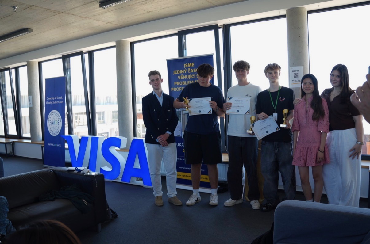 The winning team holds trophies and diplomas with the organisers at the 2026 Economics Masters Challenge